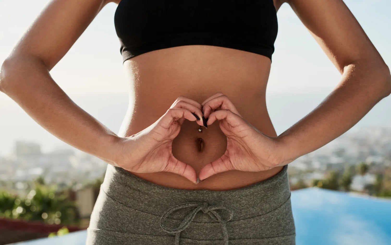Image showing woman making a heart with her fingers in front of her stomach