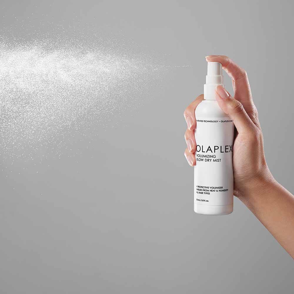 Olaplex Volumizing Blow Dry Mist - image of product with model being sprayed