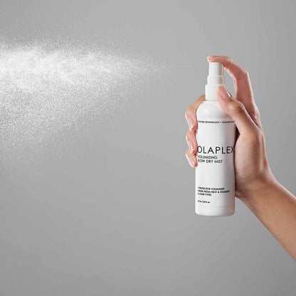 Olaplex Volumizing Blow Dry Mist - image of product with model being sprayed